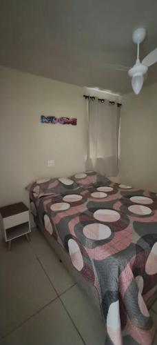 a bedroom with a large bed with a patterned blanket at Intermares perto de tudo com 3 quartos in Cabedelo