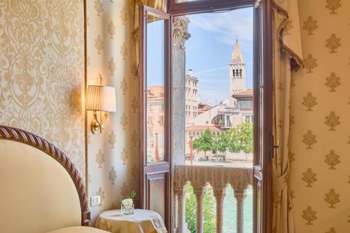 a room with a window with a view of the city at Hotel Palazzo Stern in Venice