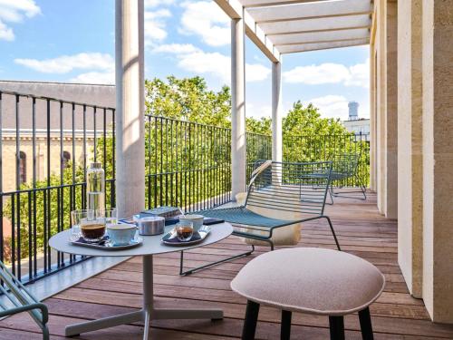 a patio with a table and chairs on a balcony at TRIBE Paris Clichy in Clichy