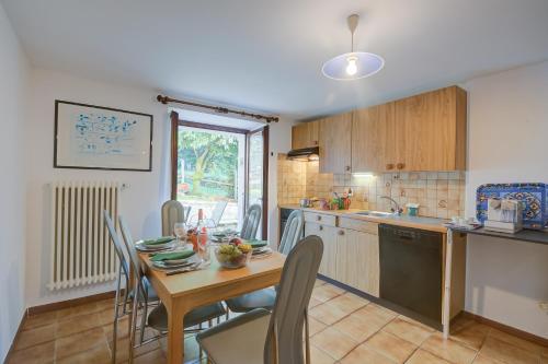 a kitchen and dining room with a table and chairs at Ca Cornocc with Private Terrace in Gordola - Happy Rentals in Gordola