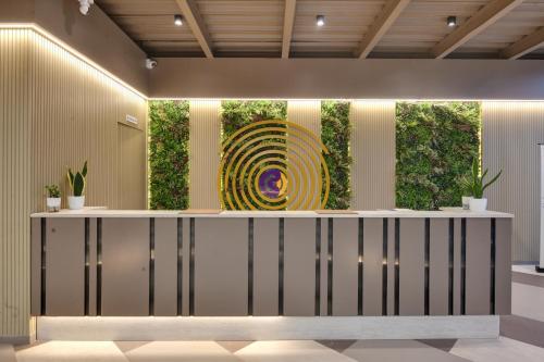a lobby with a large painting on the wall at Click Hotels Lite Chakan in Pune