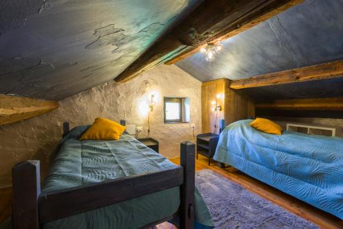 a bedroom with two beds in a attic at Dimora Dory Luxury in Nave
