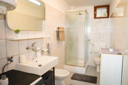 a bathroom with a sink and a toilet and a shower at Castello in Mali Lošinj