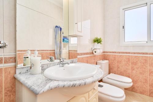 a bathroom with a sink and a toilet at Dúplex céntrico, 2 grandes terrazas in Nerja
