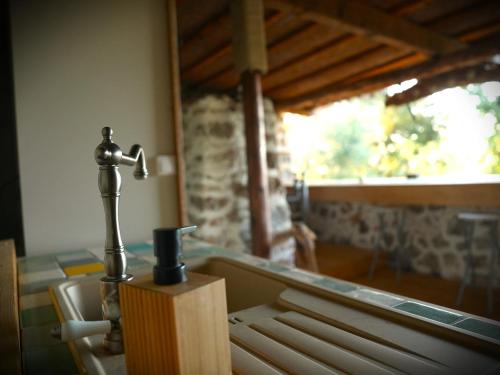 a table with a candle and a holder in a room at Le Ptit Mas Yourte ou Logicube in Salernes