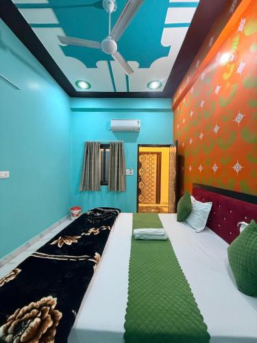 a bedroom with a bed with a green and blue ceiling at Keshav Vatika Palace - 800 meter Ram Mandir in Ayodhya
