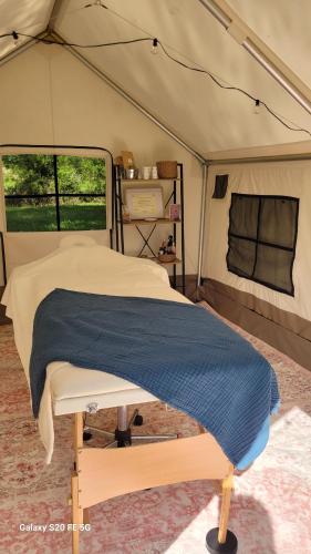 a bedroom in a tent with a bed in it at CHEZ JOSETTE caravane Camping le sorbier Montignac Lascaux in Montignac