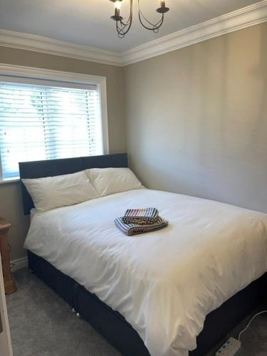 a bedroom with a white bed with a window at Ambermay House in Armagh