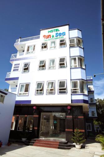 a white building with a sign on it at Sun & Sea Hotel in Phu Quoc