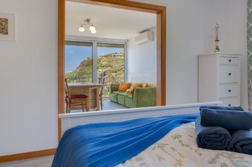 a bedroom with a bed and a large mirror at Studio SeaSky Tabua by Holiday Rental Madeira in Ribeira Brava