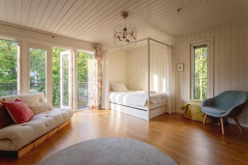 a living room with a bed and a couch at Stay North - Peikkola in Kirkkonummi