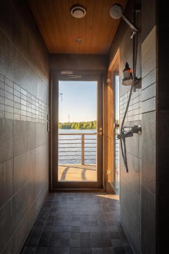a bathroom with a view of the water through a window at Stay North - Peikkola in Kirkkonummi