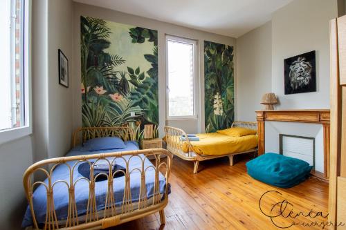 a living room with two beds and a fireplace at Evasion in Albi