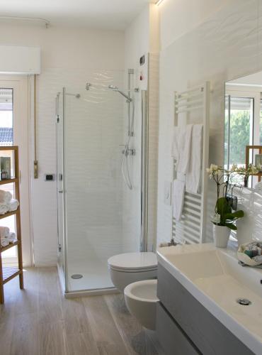 a bathroom with a shower and a toilet and a sink at Residence Dolce Vita in San Benedetto del Tronto