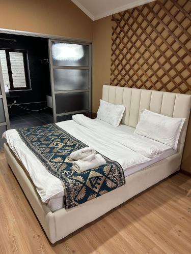 a large bed with white sheets and pillows on it at Gatsby Ortosay in Orto-Say