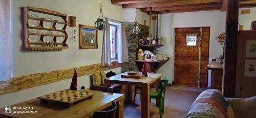 a living room with a table and a chessboard at B&B Baita Bertolini in Monclassico