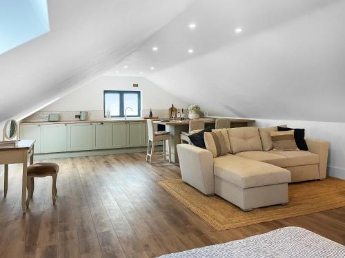 a living room with a couch and a table at Gatherley Loft in Scorton