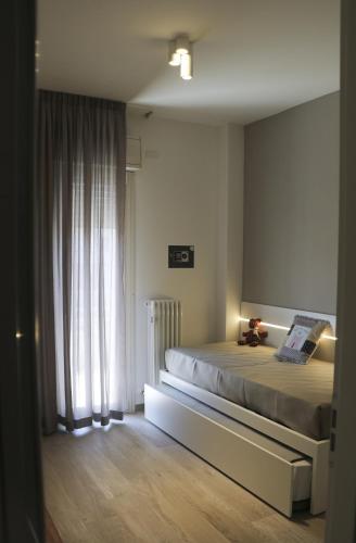 a bedroom with a bed and a window at Residence Dolce Vita in San Benedetto del Tronto