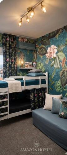 a bedroom with two bunk beds and a floral wall at Amazon Hostel Center Podgorica in Podgorica
