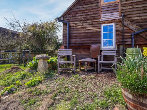 a house with two chairs and a bench and a table at The Old Tack Room - Uk49233 in Tilshead