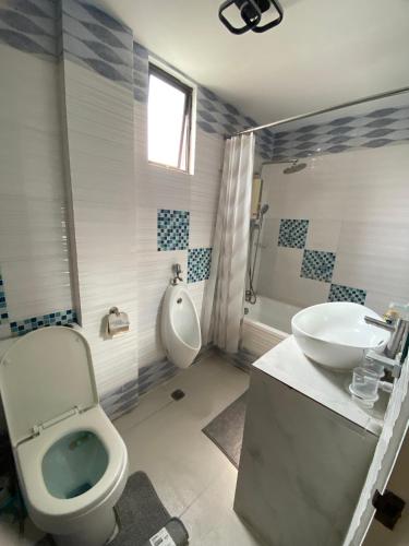 a bathroom with a toilet and a sink at Casa Buenafe in Antipolo