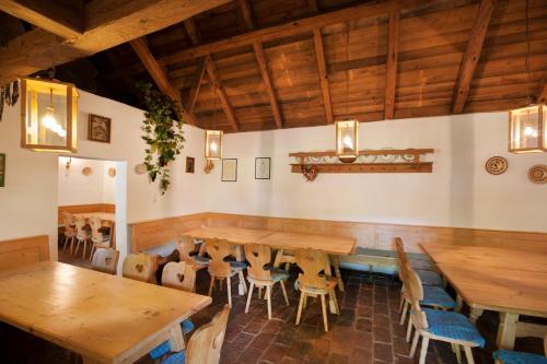a dining room with wooden tables and chairs at Landhotel Schwabenhof in Heiligenbrunn