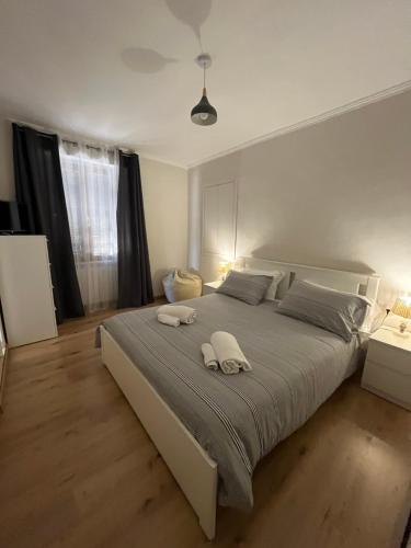 a bedroom with a large bed with two towels on it at Appartamento Cavour in Ventimiglia