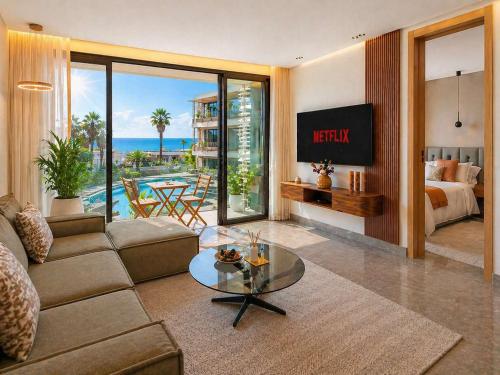 a living room with a couch and a bed and a table at The Iconic Spot - Pool and Sea View in Anfa-Supérieur