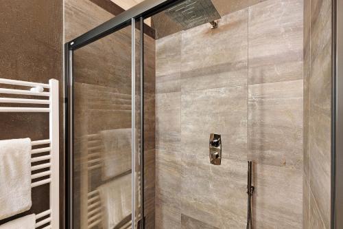 a shower with a glass door in a bathroom at Archerhof in Racines