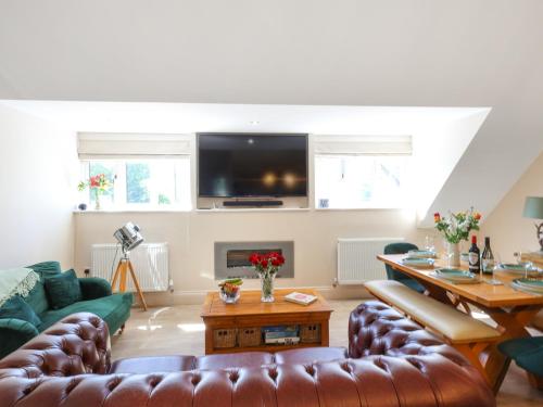 a living room with a couch and a table at Kendalls Nook in Shaftesbury