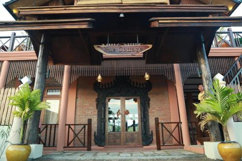 a building with a door with a sign above it at Inle Cottage Boutique Hotel in Nyaung Shwe