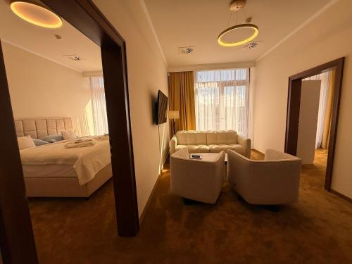 a hotel room with a bed and a mirror at Hotel International in Tatranská Lomnica