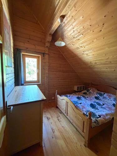 a bedroom with a bed in a wooden cabin at Au bord du lac III in Montigny-en-Morvan