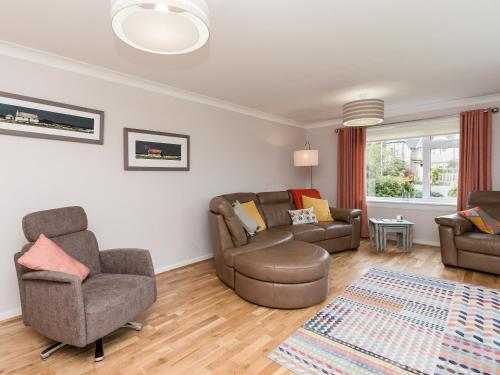 a living room with two couches and a couch and a chair at Sheeoch in Comrie