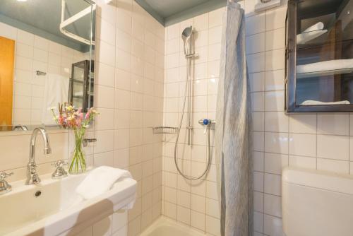 a bathroom with a shower and a sink at Chesa Survial 4 in Sils Maria