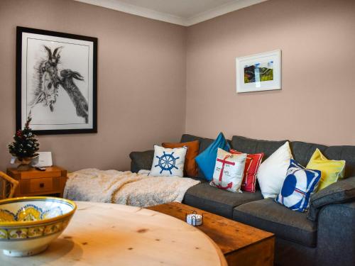 a living room with a couch and a table at Marina Views in Amble