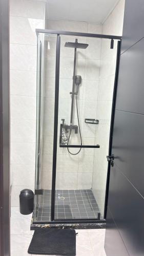 a shower in a bathroom with a glass enclosure at The Captains Suite in Gaborone