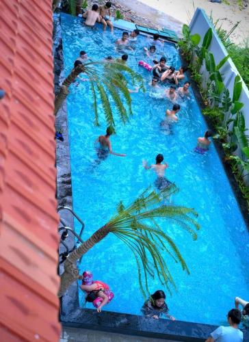 a group of people swimming in a swimming pool at Trang An Mountain Ecologe in Xuân Sơn