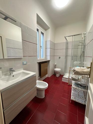 a bathroom with a sink and a toilet and a shower at L'Angolo di Mede in Mede