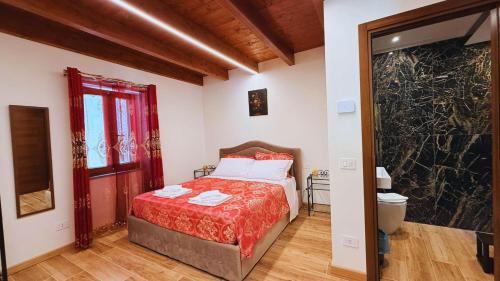 a bedroom with a bed with a red blanket at Residence Besano in Besano