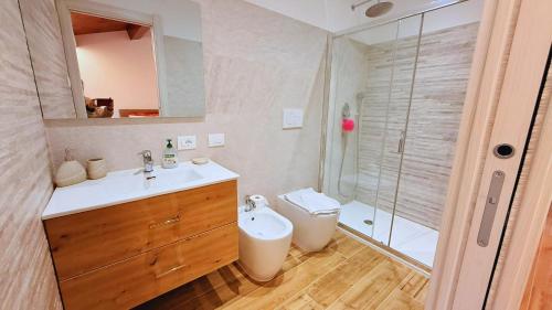 a bathroom with a sink and a toilet and a shower at Residence Besano in Besano