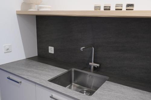 a kitchen with a sink and a counter top at Chesa Piol Studio in Maloja