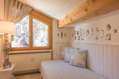 a bedroom with a bed and a window at Chesa Maria 7 in Sils Maria