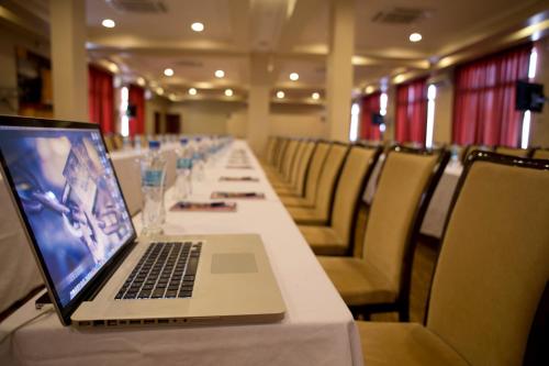 a laptop computer sitting on a long table at Seascape Hotel in Dar es Salaam