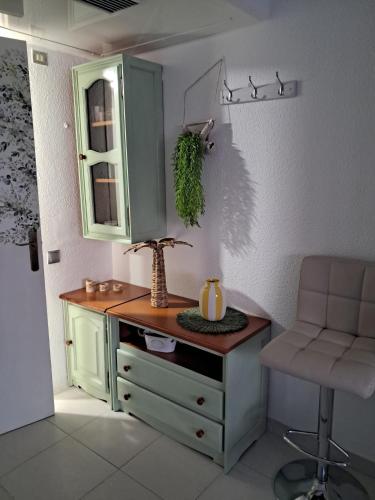 a room with a desk and a chair and a cabinet at Apartahotel Estudio 221 in Matalascañas