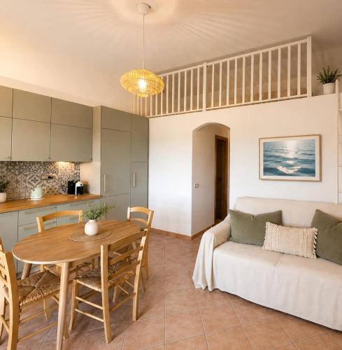 a living room with a couch and a table at Villetta Vista Paradiso in Costa Paradiso