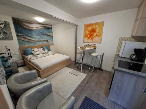 a small room with a bed and a table at Frix Balaton in Balatonalmádi