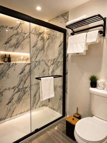 a bathroom with a shower and a toilet at Lake George Residence LLC in South Glens Falls