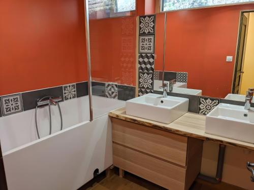 a bathroom with two sinks and a shower at Au Son Du Diois in Die