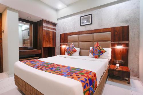 a bedroom with a large bed in a room at FabHotel Prasad International in Mumbai